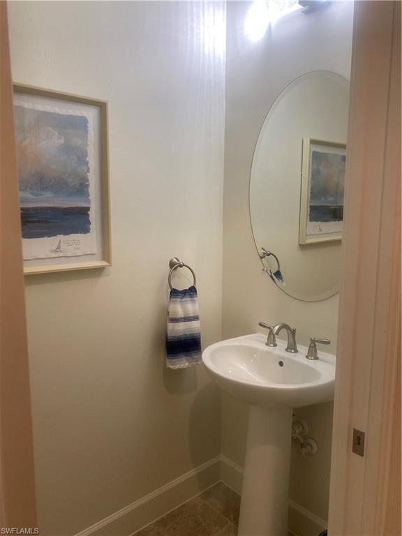 9571 Mussorie Court Naples, FL 34114 - Photo 21 of 26 a bathroom with a sink and mirror with toilet