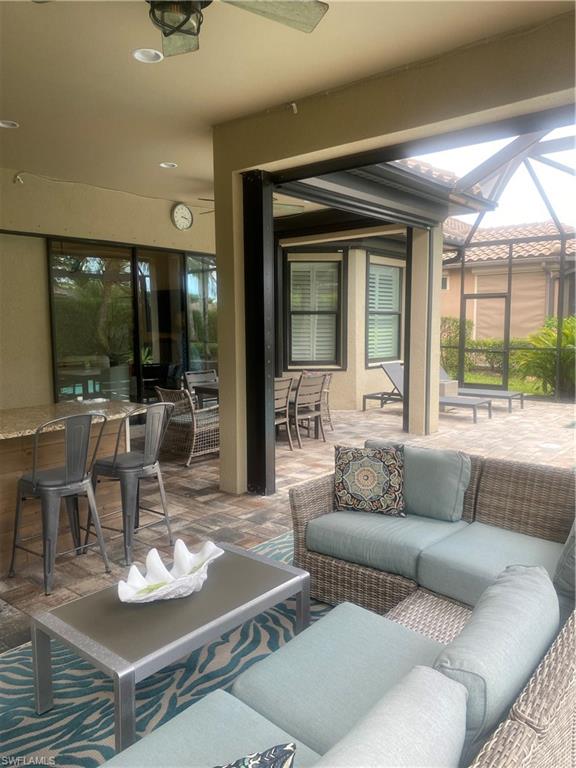 9571 Mussorie Court Naples, FL 34114 - Photo 24 of 26 a living room with furniture and a large window