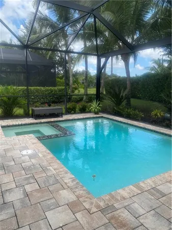 a view of a swimming pool with a yard