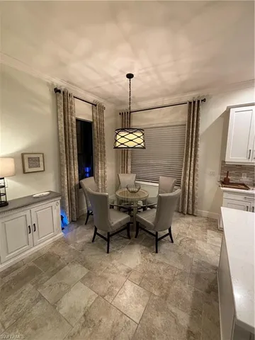 a living room with furniture and a kitchen view