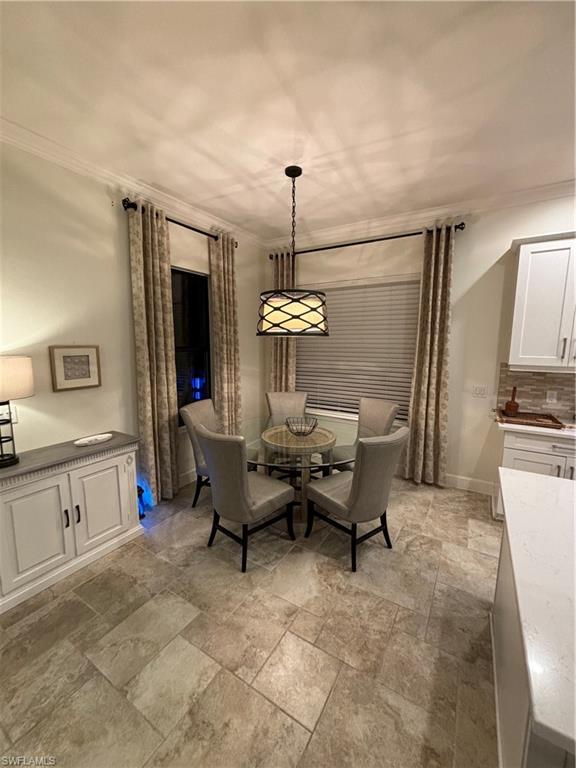 9571 Mussorie Court Naples, FL 34114 - Photo 5 of 26 a living room with furniture and a kitchen view