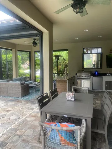 a dining room with furniture and a floor to ceiling window