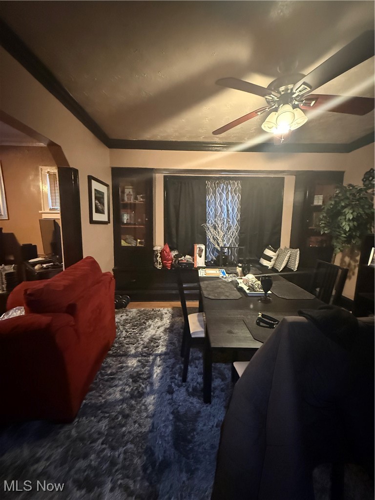 1667 Burgess Road Cleveland, OH 44112 - Photo 22 of 31 Dining area with a ceiling fan, ornamental molding, and arched walkways