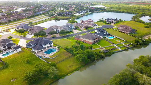 an aerial view of a houses with a lake view