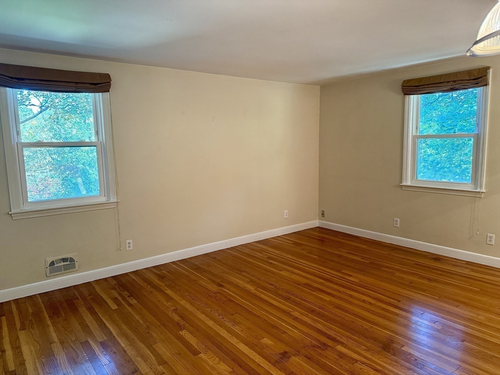 14 Lilac Circle Wellesley, MA 02482 - Photo 11 of 35 a view of an empty room with wooden floor and a window