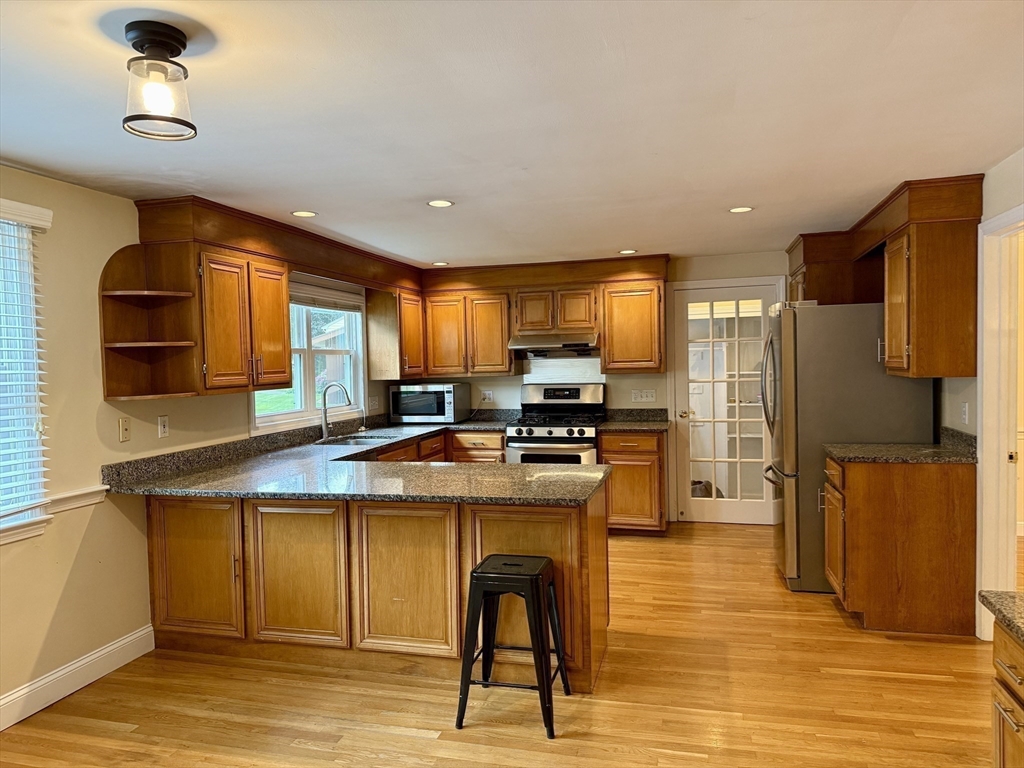 14 Lilac Circle Wellesley, MA 02482 - Photo 2 of 35 a kitchen with stainless steel appliances granite countertop a refrigerator a stove and a sink