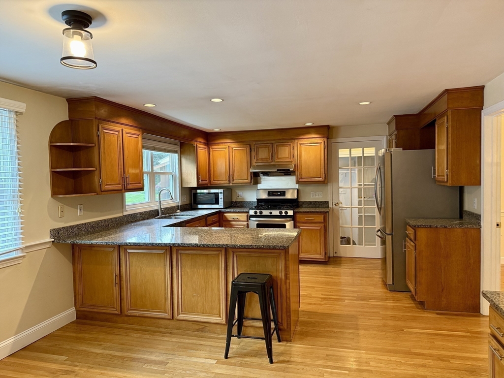 14 Lilac Circle Wellesley, MA 02482 - Photo 2 of 35 a kitchen with stainless steel appliances granite countertop a refrigerator a stove and a sink