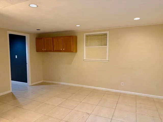 an empty room with cabinet and white walls