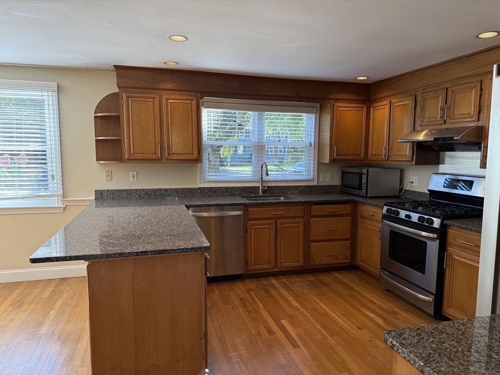 14 Lilac Circle Wellesley, MA 02482 - Photo 3 of 35 a kitchen with granite countertop wooden floors and stainless steel appliances
