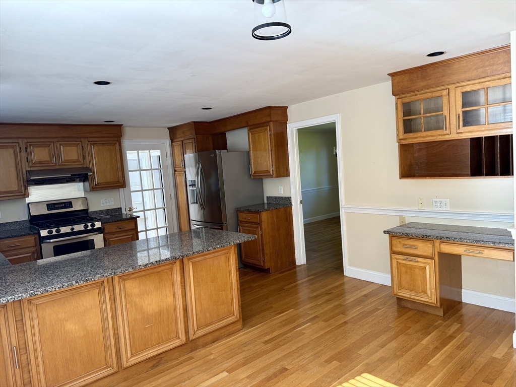 14 Lilac Circle Wellesley, MA 02482 - Photo 4 of 35 a kitchen with stainless steel appliances granite countertop a stove a sink and a refrigerator