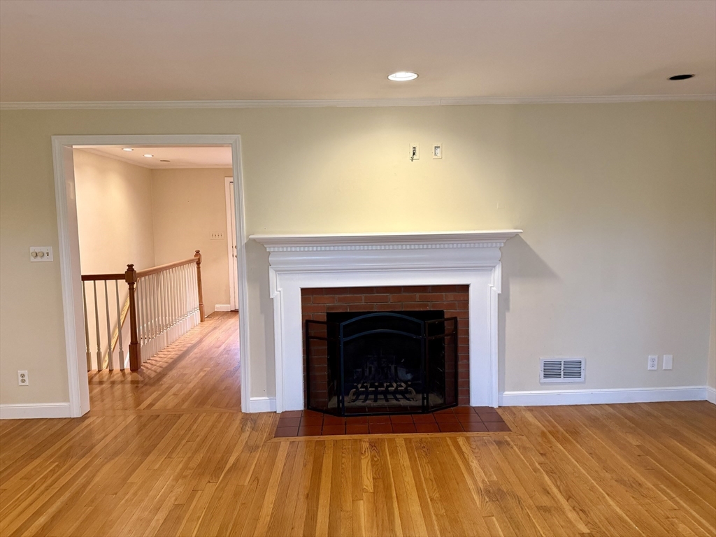 14 Lilac Circle Wellesley, MA 02482 - Photo 7 of 35 a living room with wooden floor and a fireplace