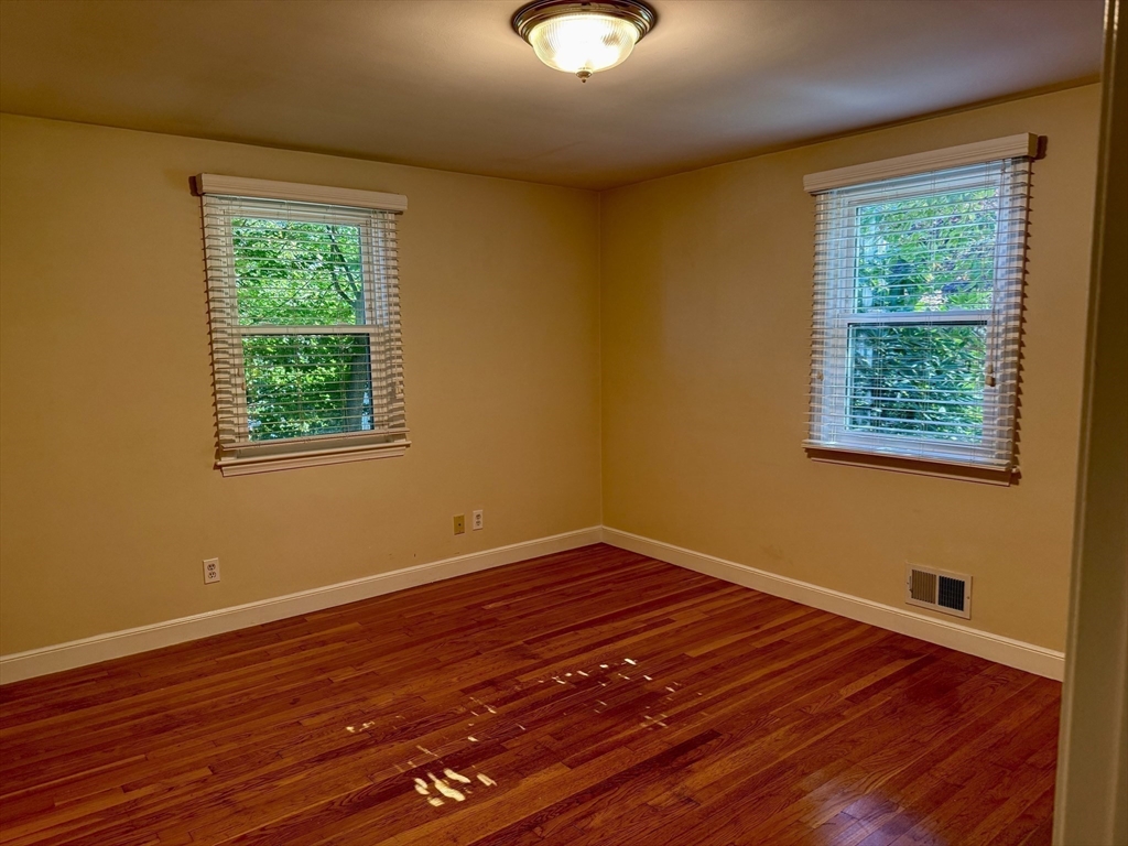 14 Lilac Circle Wellesley, MA 02482 - Photo 10 of 35 a view of an empty room with wooden floor and a window
