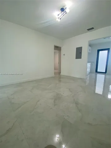 an empty room with a empty space and windows