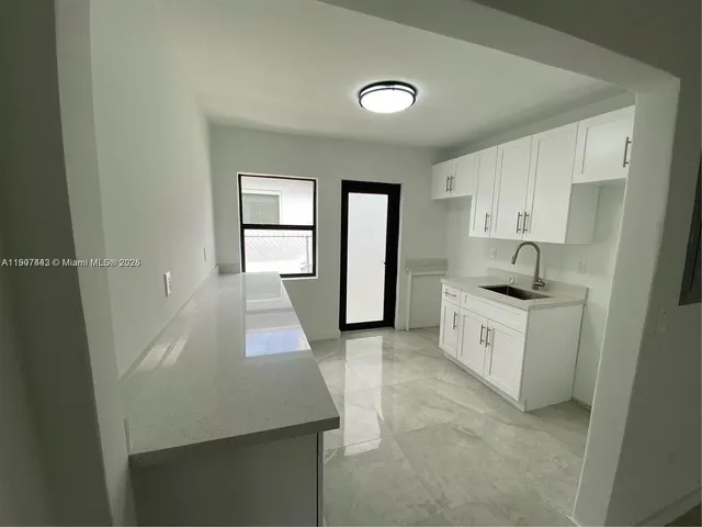 a kitchen with sink and window