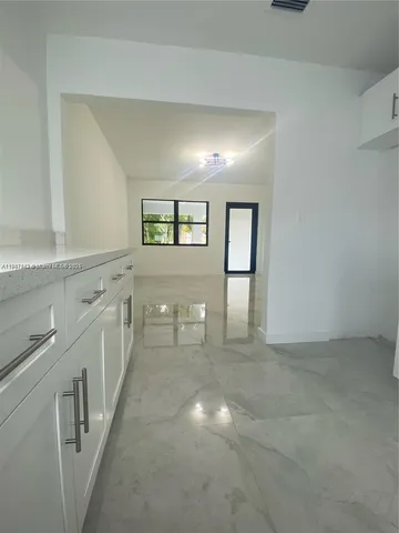 a view of a hallway with a sink