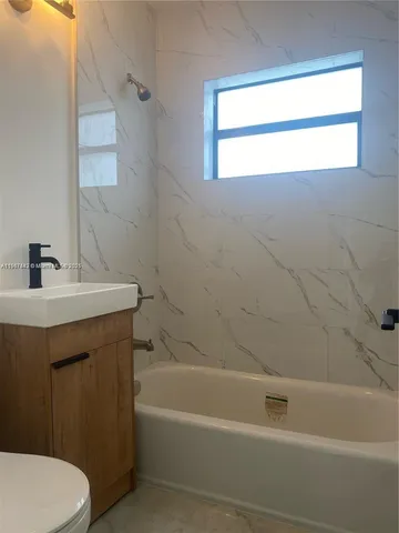 a bathroom with a sink a toilet and a bathtub