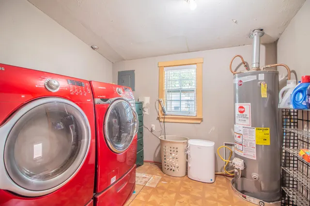 a view of a house with a big yard and large trees
