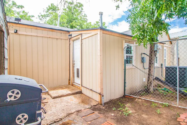 a view of a house with backyard and patio