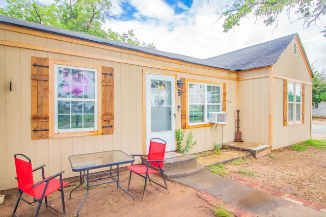a backyard of a house with outdoor seating