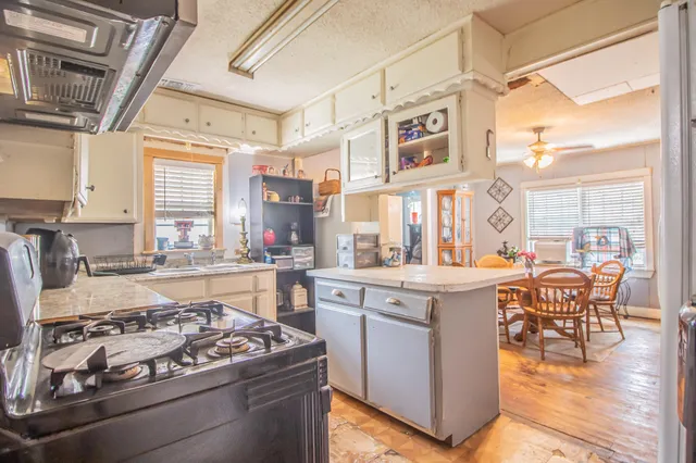 a kitchen with stainless steel appliances granite countertop a stove and a refrigerator