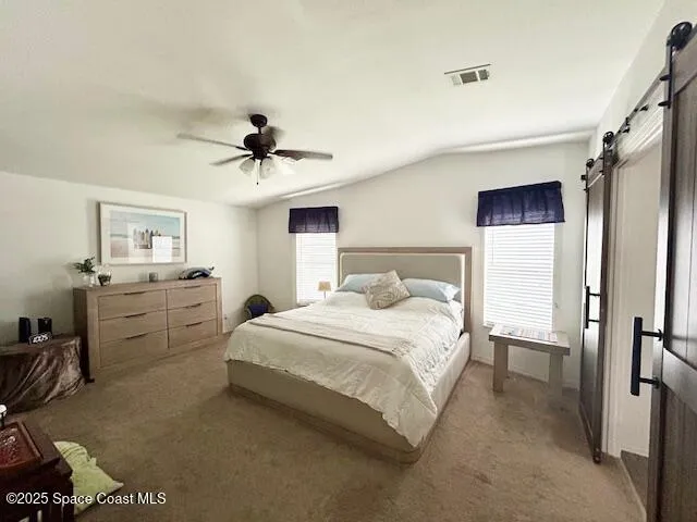 a bedroom with a bed and a ceiling fan