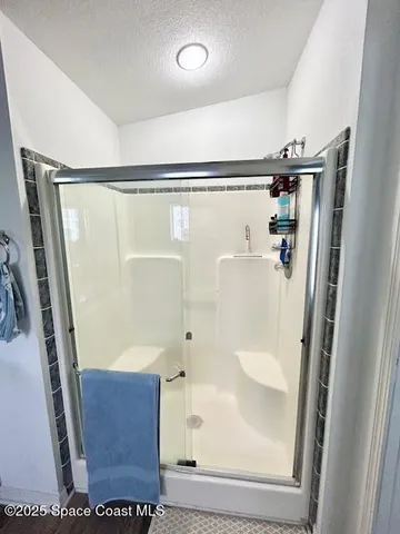 a bathroom with a glass shower door