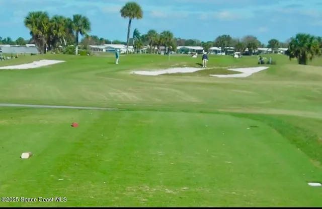 a view of a golf course with a lake