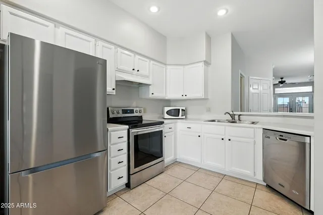 a kitchen with cabinets appliances and a sink