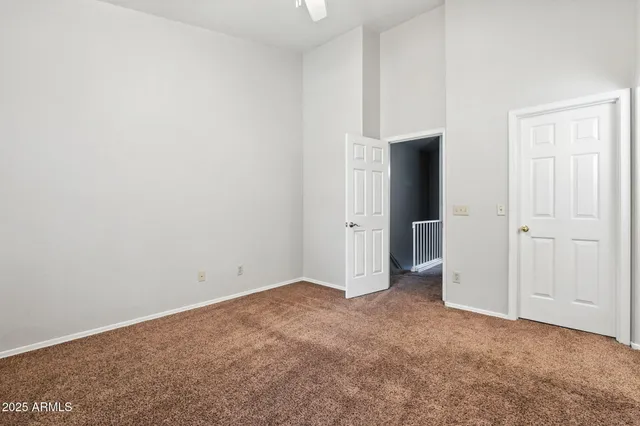 an empty room with closet and mirror