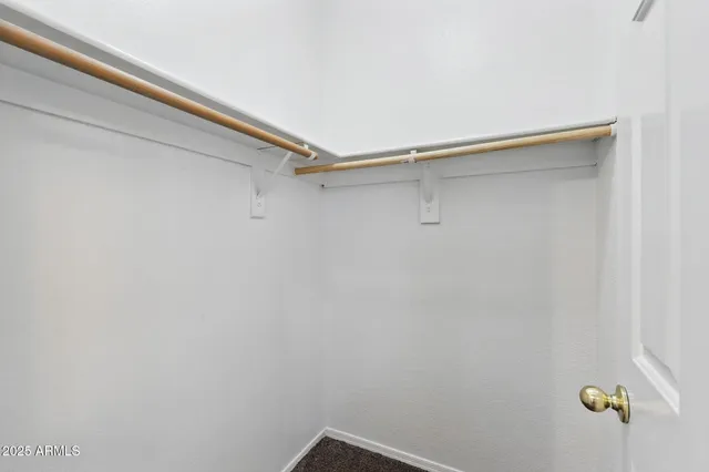 an empty room with closet and a bathroom