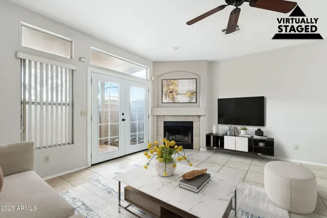 a living room with furniture a flat screen tv and a fireplace