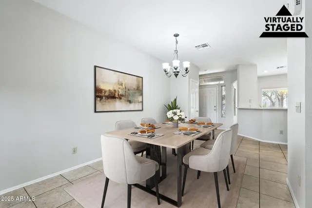 a view of a dining room with furniture and chandelier