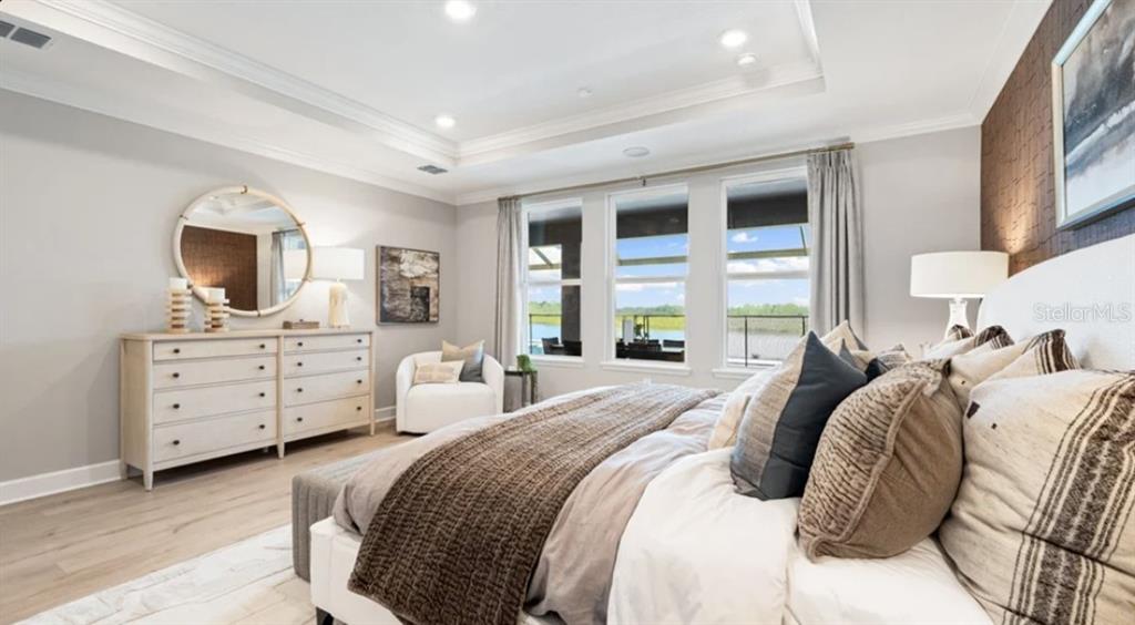 13618 Cornerstone Way Parrish, FL 34219 - Photo 11 of 27 a bedroom with a bed and a dresser