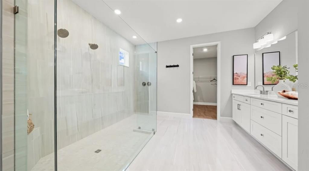 13618 Cornerstone Way Parrish, FL 34219 - Photo 13 of 27 a spacious bathroom with a granite countertop sink mirror shower and a bathtub