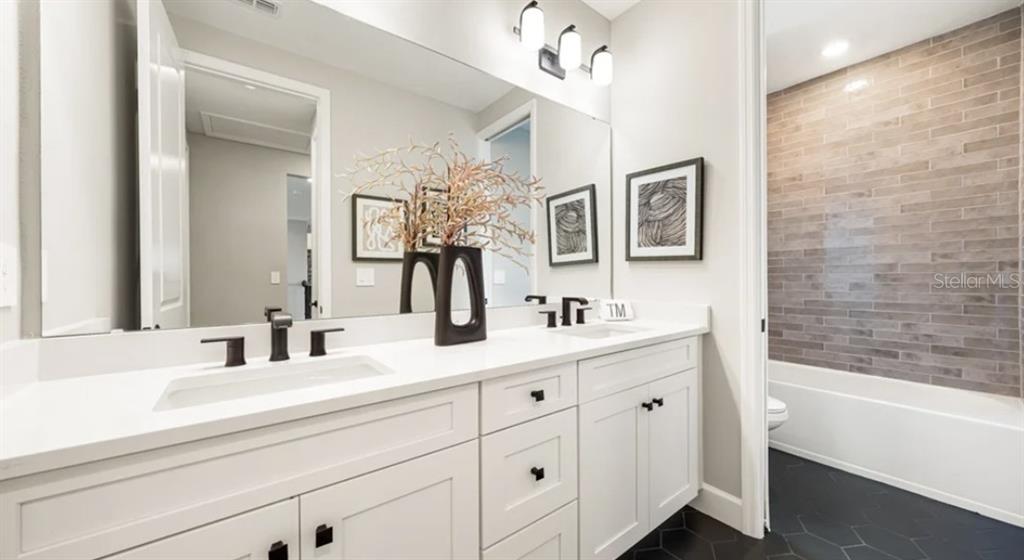 13618 Cornerstone Way Parrish, FL 34219 - Photo 19 of 27 a bathroom with a double vanity sink mirror and bathtub