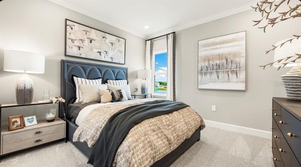 13618 Cornerstone Way Parrish, FL 34219 - Photo 20 of 27 a bedroom with bed and paintings on the wall