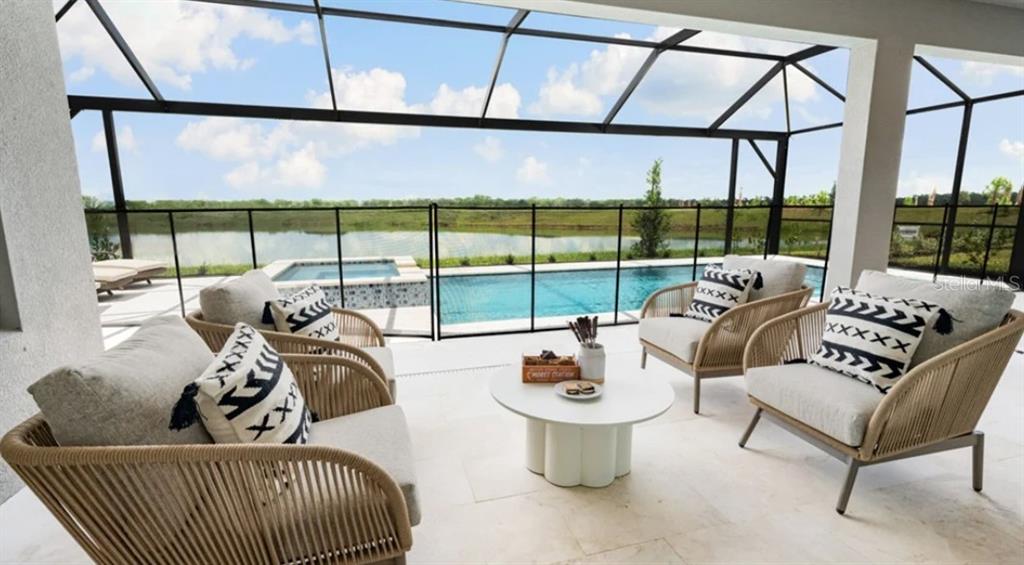 13618 Cornerstone Way Parrish, FL 34219 - Photo 21 of 27 a living room with furniture and a floor to ceiling window
