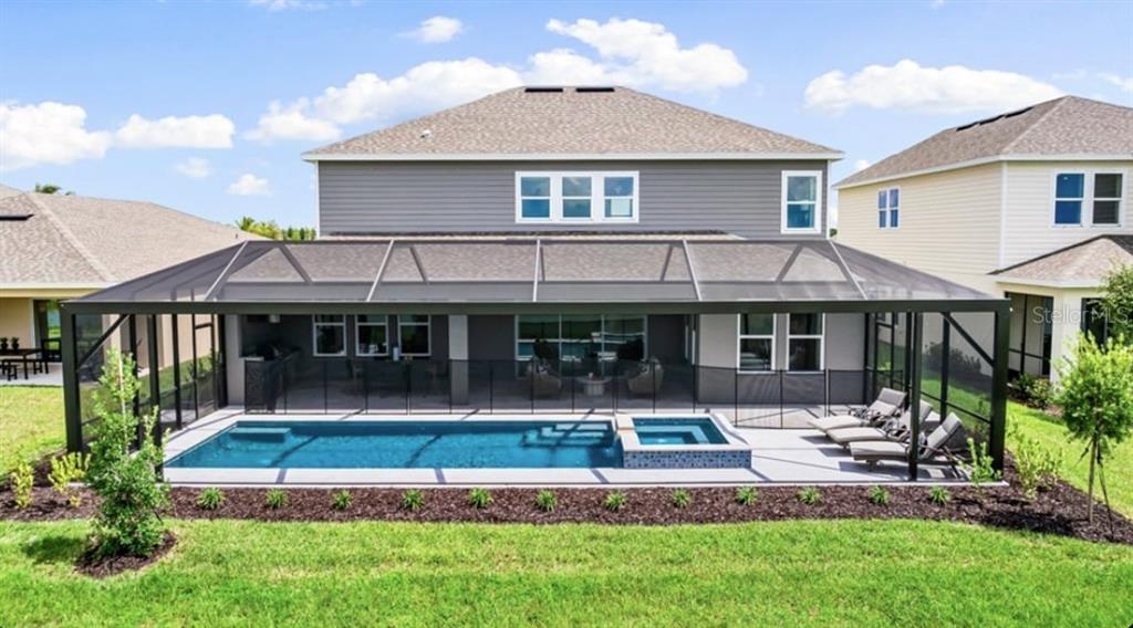 13618 Cornerstone Way Parrish, FL 34219 - Photo 24 of 27 a front view of a house with a yard table and chairs