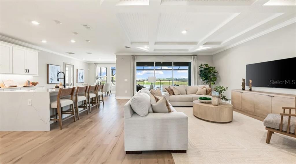 13618 Cornerstone Way Parrish, FL 34219 - Photo 3 of 27 a living room with furniture and a flat screen tv