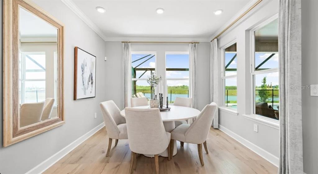 13618 Cornerstone Way Parrish, FL 34219 - Photo 7 of 27 a view of a dining room with furniture large windows and wooden floor