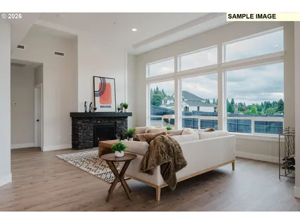 a bedroom with furniture and a large window