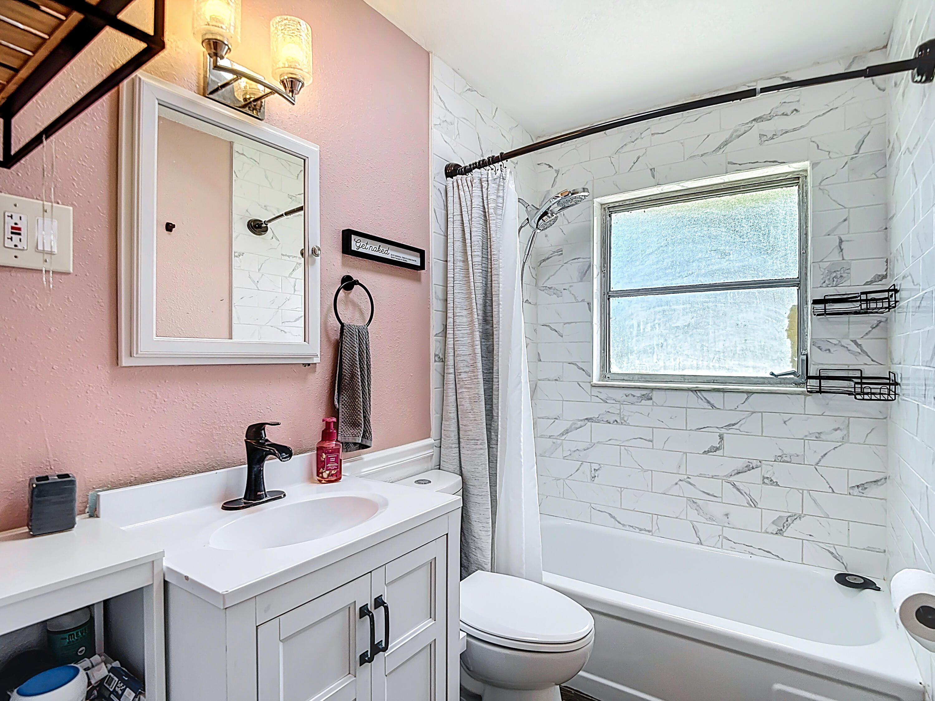 5335 Lemon Avenue Seffner, FL 33584 - Photo 19 of 34 a bathroom with a sink vanity mirror and toilet