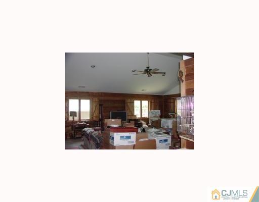 27 MacAfee Road Somerset, NJ 08873 - Photo 2 of 8 a open living room with kitchen island furniture and a chandelier