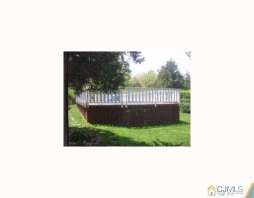 27 MacAfee Road Somerset, NJ 08873 - Photo 5 of 8 a view of a bench in the backyard