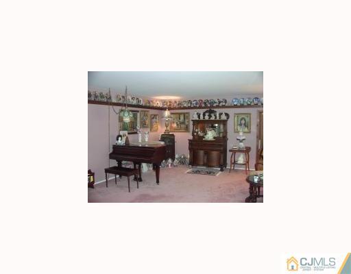 27 MacAfee Road Somerset, NJ 08873 - Photo 8 of 8 a living room with furniture and a flat screen tv