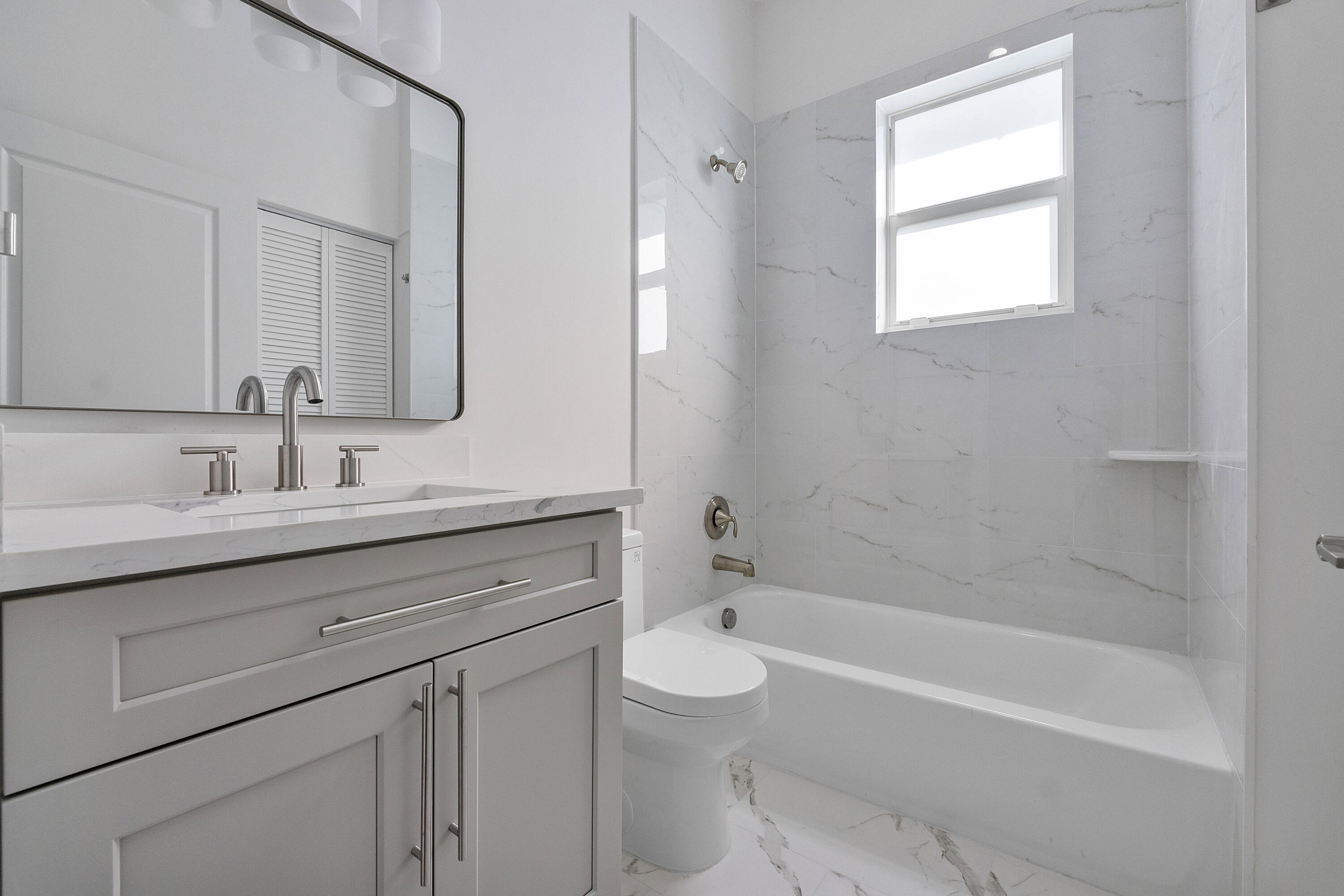 1573 West 16th Street Riviera Beach, FL 33404 - Photo 13 of 23 a bathroom with a sink a toilet and bathtub