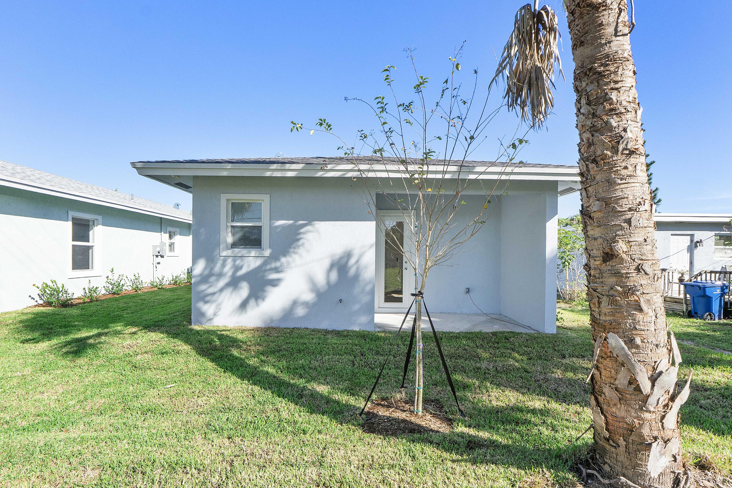 1573 West 16th Street Riviera Beach, FL 33404 - Photo 20 of 23 a front view of a house with garden