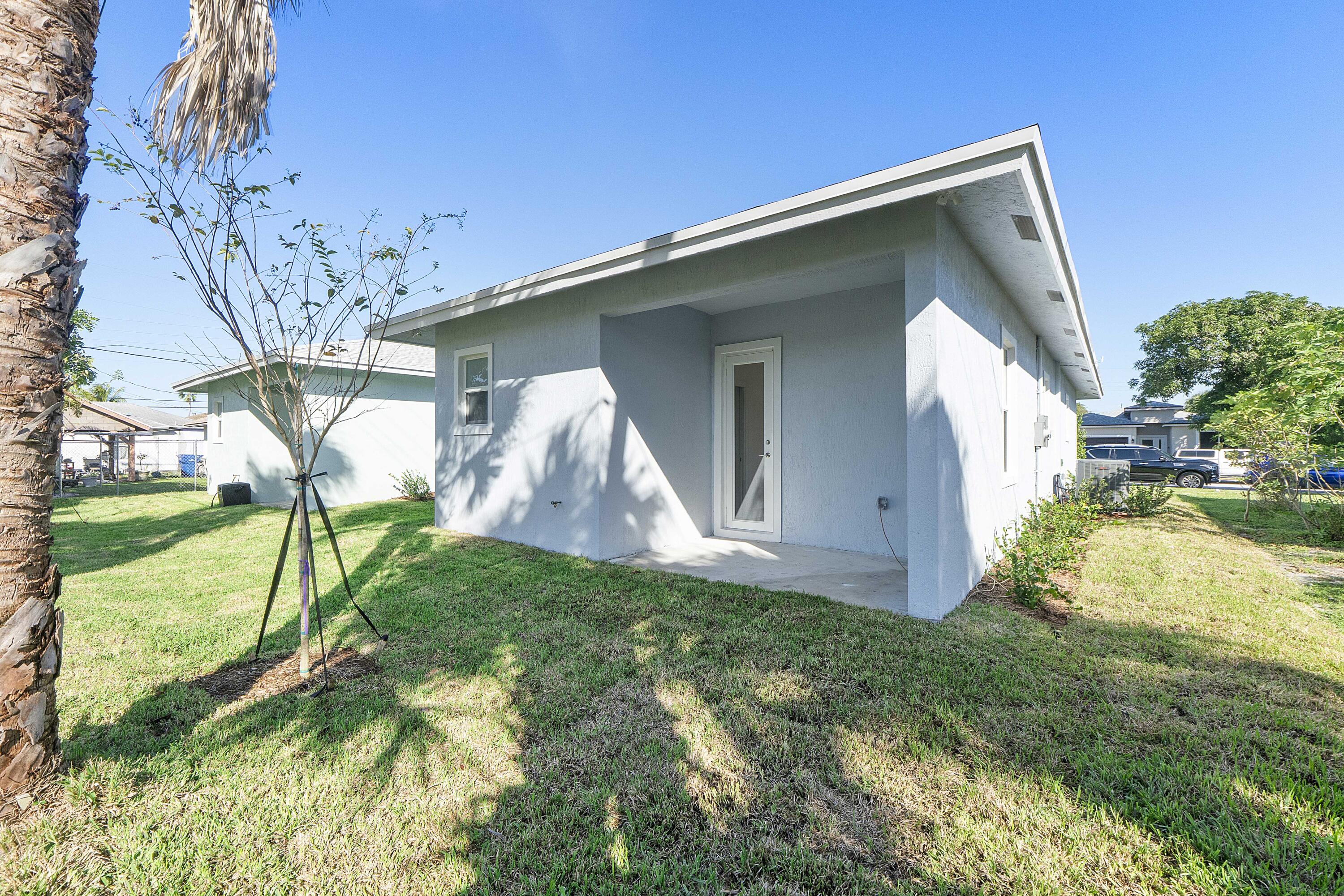 1573 West 16th Street Riviera Beach, FL 33404 - Photo 23 of 23 a view of backyard with a garden and plants