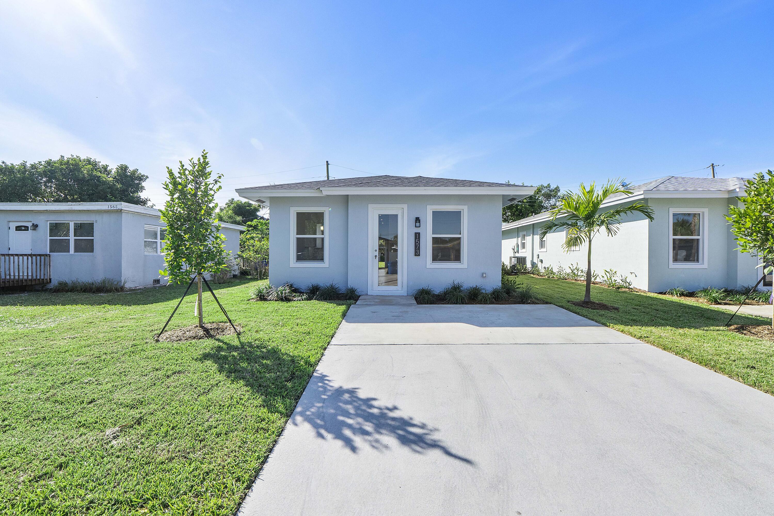 1573 West 16th Street Riviera Beach, FL 33404 - Photo 3 of 23 a view of a house with a yard