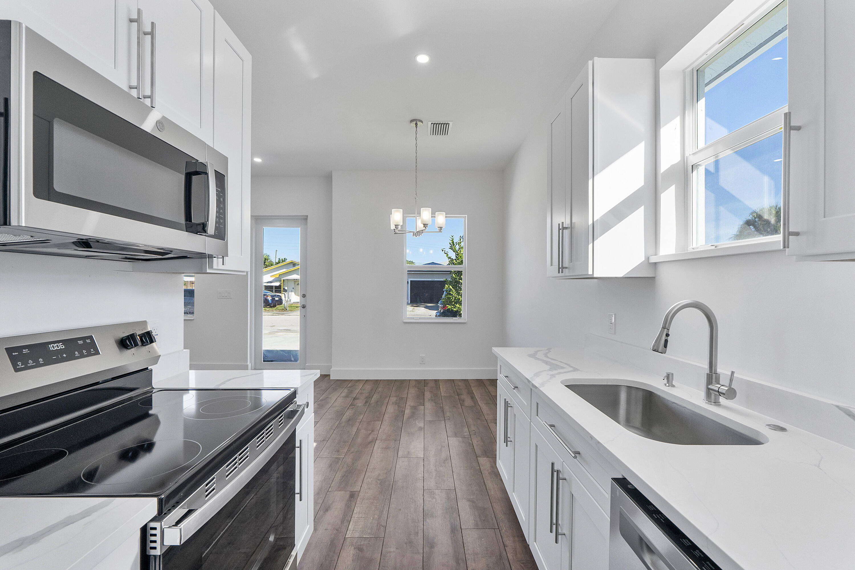 1573 West 16th Street Riviera Beach, FL 33404 - Photo 7 of 23 a kitchen with a sink stove and microwave
